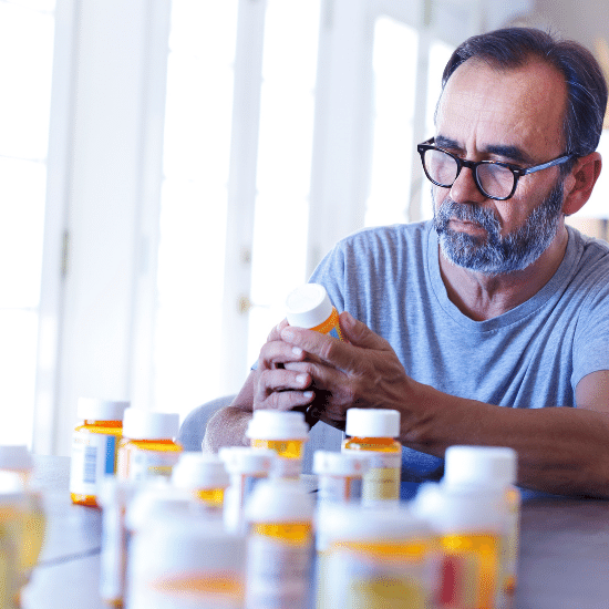 Man reading prescriptions